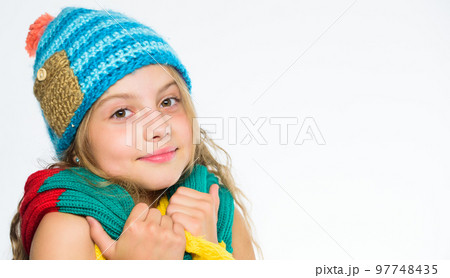 Warm woolen accessories. Girl happy face white background. Hat and scarf keep warm. Kid wear warm knitted hat and long scarf. Fall fashion concept. Which fabrics will keep you warmest this autumn Warm woolen accessories. Girl happy face white background. Hat and scarf keep warm. Kid wear warm knitted hat and long scarf. Fall fashion concept. Which fabrics will keep you warmest this autumn 97748435
