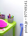 Children's table with pencils for drawing and toys in the nursery. Children's background is bright with copy space. Preschool education 97749141