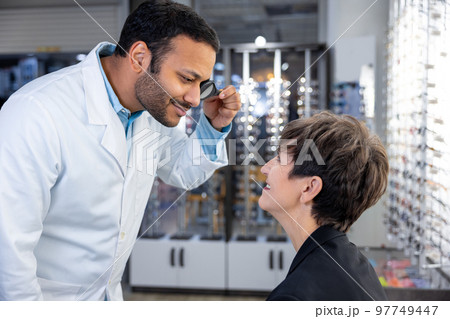 Mid aged woman having a visit to ophtolmalogical clinic Mid aged woman having a visit to ophtolmalogical clinic 97749447