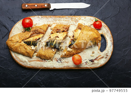 Scomber fish baked in dough. Scomber fish baked in dough. 97749555