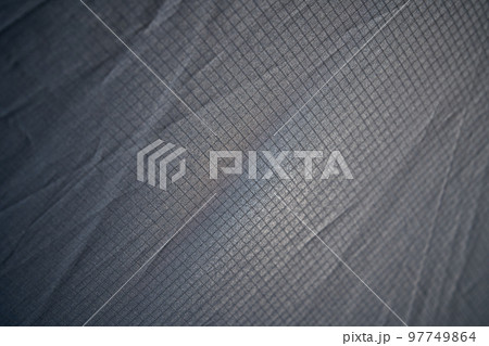 Abstract modern mesh material texture for unusual backdrop. Light weight wrinkled seamless pattern of pale gray plaid fabric for wallpaper or art ideas. Concept of textures and background. 97749864