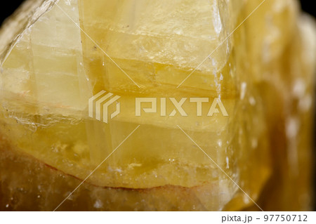 Macro mineral stone yellow Calcite on a black background Macro mineral stone yellow Calcite on a black background 97750712