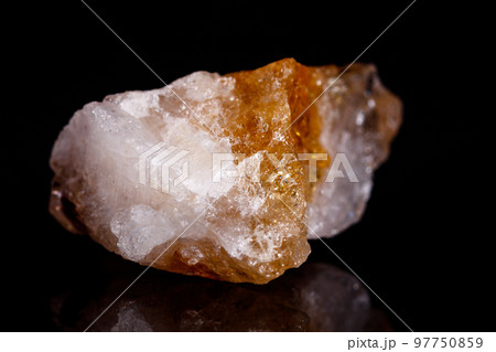 Macro mineral stone Citrine on black background 97750859