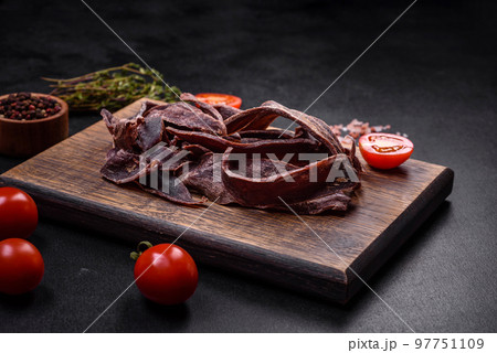 Delicious salted dried beef cut into slices as an appetizer for beer 97751109