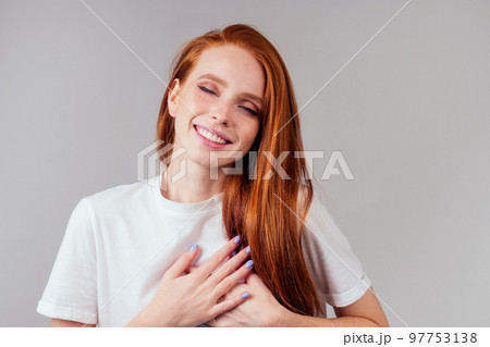 happy redhair ginger woman in studio background feeling heart thanks happy redhair ginger woman in studio background feeling heart thanks 97753138