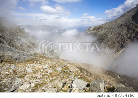 Above the clouds in the mountains near the Ried Glacier (Gasenried, Valais, Switzerland) 97754360