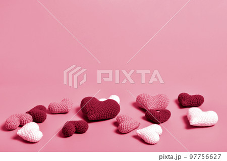 Scattered hearts. Color 2023, viva magenta. Background for Valentine's Day. 97756627