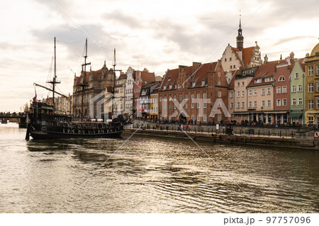 Beautiful old town of Gdansk over Motlawa river Vintage ship pirate caravels sailing on Motlawa river with historic port Crane in Old Town on background. Gdansk, Poland. This ship imitating XVII Beautiful old town of Gdansk over Motlawa river Vintage ship pirate caravels sailing on Motlawa river with historic port Crane in Old Town on background. Gdansk, Poland. This ship imitating XVII 97757096