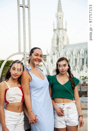 Tourists at the Ortiz Bridge with La Ermita church on background in the city of Cali in Colombia 97757153