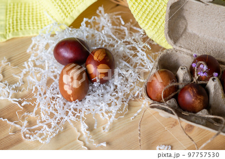 Painted eggs cooked for Easter are in an eco-friendly tray on the table 97757530