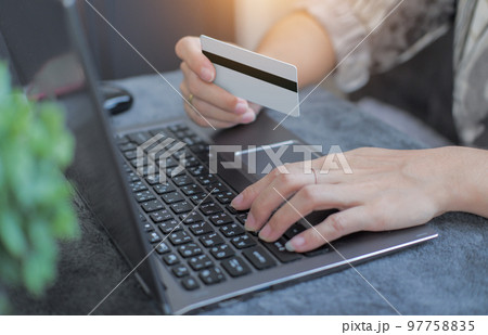 credit card filling in billing information in purchase of laptop computer in ecommerce store. Concept: online payment. Internet accessible money transactions credit card filling in billing information in purchase of laptop computer in ecommerce store. Concept: online payment. Internet accessible money transactions 97758835
