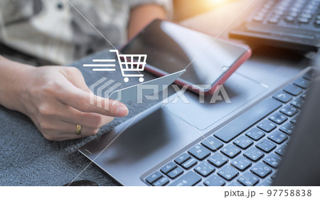 credit card filling in billing information in purchase of laptop computer in ecommerce store. Concept: online payment. Internet accessible money transactions 97758838