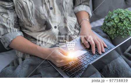 credit card filling in billing information in purchase of laptop computer in ecommerce store. Concept: online payment. Internet accessible money transactions 97758839