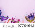 Table top view aerial image of beautiful colorful carnival festival background.Flat lay accessory object the several mask  decor confetti on modern pink paper at home office desk studio.copy space.. 97764648