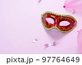 Table top view aerial image of beautiful colorful carnival festival background.Flat lay accessory object the several mask  decor confetti on modern pink paper at home office desk studio.copy space.. 97764649