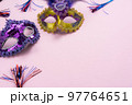 Table top view aerial image of beautiful colorful carnival festival background.Flat lay accessory object the several mask  decor confetti on modern pink paper at home office desk studio.copy space.. 97764651