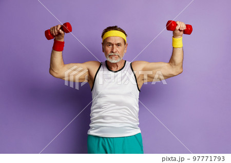 Strong Man Training With Dumbbells. Glad Grandfather Raising Arms With Dumbbells 97771793