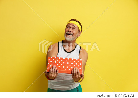 Senior Man Holding Present. Handsome Bearded Grandfather Posing With Gift Box Senior Man Holding Present. Handsome Bearded Grandfather Posing With Gift Box 97771872