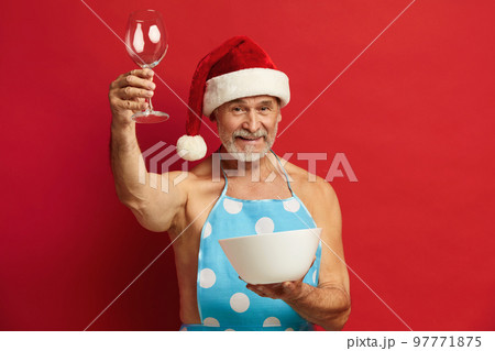 Senior Man Holding Wineglass Biceps. Bearded Man In Santa Hat And Apron 97771875