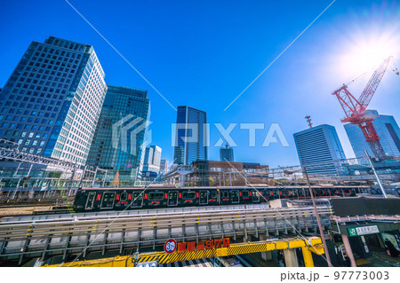日本の東京都市景観　浜松町駅（北口）や黒い山手線や超高層ビル群などを望む 97773003