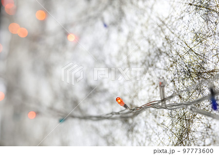 Minimal Christmas light bulb wires with cold winter white abstract background Minimal Christmas light bulb wires with cold winter white abstract background 97773600