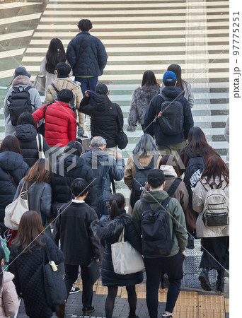 年末の街の交差点の横断歩道で歩く人々の姿 97775251