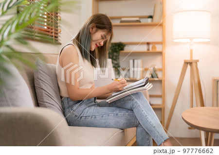 Creative design concept, Fashion designer sits on couch and drawing to create new collection dress Creative design concept, Fashion designer sits on couch and drawing to create new collection dress 97776662