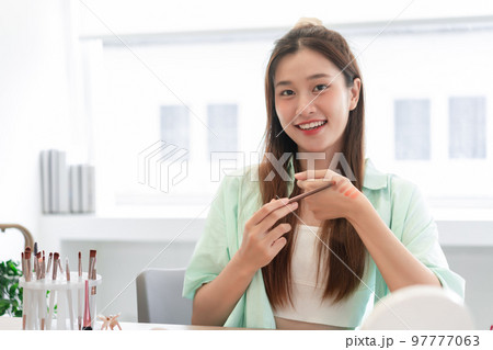 Beauty Vlogger concept, Young woman try eyeshadow on hand to review product while record video Vlog Beauty Vlogger concept, Young woman try eyeshadow on hand to review product while record video Vlog 97777063