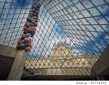 Underneath the Louvre glass pyramid. Beautiful architectural details with an abstract mixture of classical and modern architecture styles Underneath the Louvre glass pyramid. Beautiful architectural details with an abstract mixture of classical and modern architecture styles 97778145