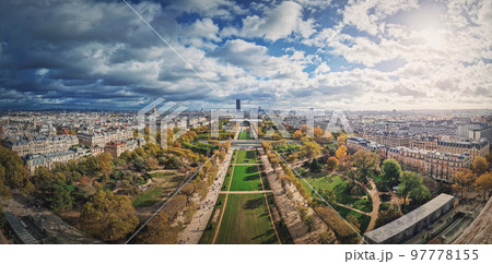 Panoramic view to the Paris cityscape from the Eiffel tower heights, France. Montparnasse tower and Les Invalides seen on the horizon panorama 97778155