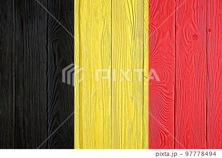 Belgium flag painted on old wood plank background. Brushed natural light knotted wooden board texture. Wooden texture background flag of Belgium. Belgium flag painted on old wood plank background. Brushed natural light knotted wooden board texture. Wooden texture background flag of Belgium. 97778494