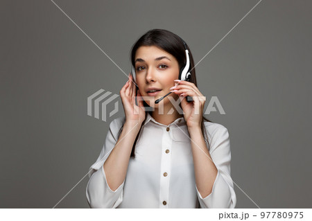 woman with headphones and microphone is consulting clients online. woman with headphones and microphone is consulting clients online. 97780975