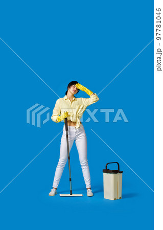 woman in rubber gloves with cleaning supplies 97781046