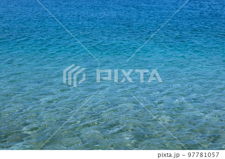 Blue transparent sea water texture. Bright ocean water background. Summer holiday concept. 97781057