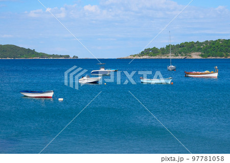 Boat parking in summer. Marina and boats moored in blue bay in Montenegro. Picturesque bay, travels. Sunny summer day. 97781058