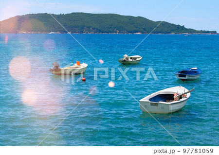 Boat parking in summer. Marina and boats moored in blue bay in Montenegro. Picturesque bay. Sunny summer day. 97781059