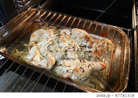 Chicken breast is fried, cooking process. Process of cooking spicy chicken meat in oven. Close up. Chicken breast is fried, cooking process. Process of cooking spicy chicken meat in oven. Close up. 97781316
