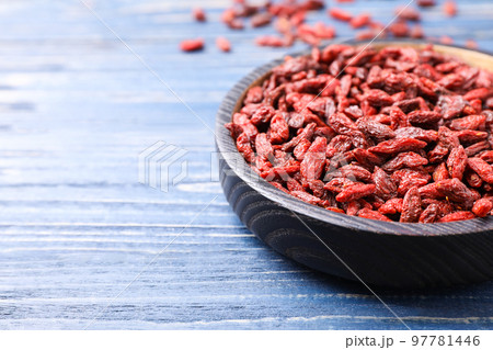 Dried goji berries on blue wooden table, closeup 97781446