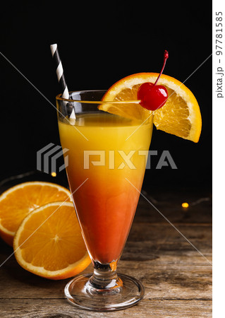 Fresh alcoholic Tequila Sunrise cocktail on wooden table 97781585
