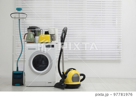 Different household appliances near window in room. Space for text 97781976