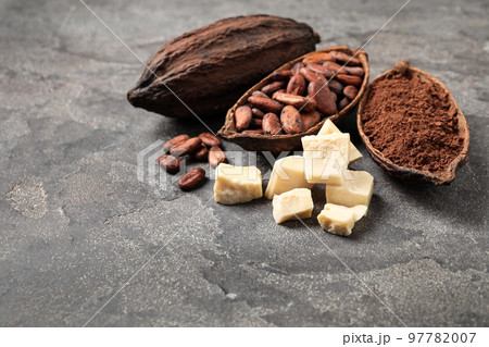 Organic cocoa butter, beans and powder on grey table 97782007