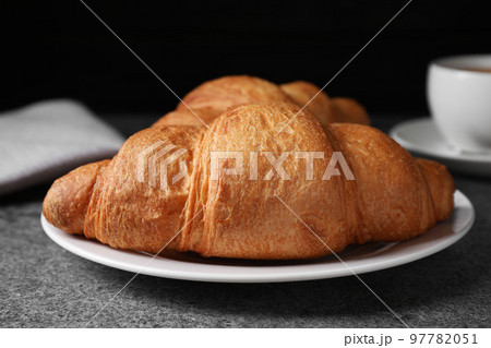 Tasty fresh croissants on grey table, closeup 97782051