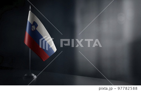 Small national flag of the Slovenia on a black background 97782588