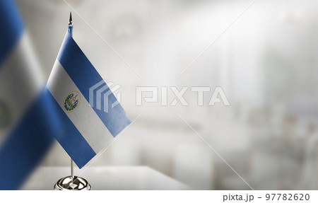 Small flags of the Salvador on an abstract blurry background Small flags of the Salvador on an abstract blurry background 97782620