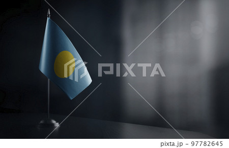 Small national flag of the Palau on a black background 97782645