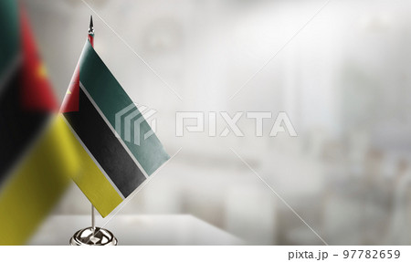 Small flags of the Mozambique on an abstract blurry background Small flags of the Mozambique on an abstract blurry background 97782659