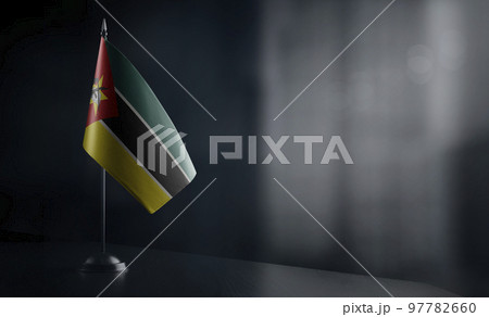 Small national flag of the Mozambique on a black background 97782660