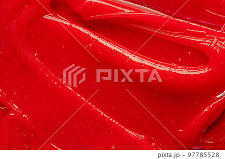 Red gel texture. Cosmetic clear liquid cream smudge. Skin care product sample closeup. Toothpaste or wax Red gel texture. Cosmetic clear liquid cream smudge. Skin care product sample closeup. Toothpaste or wax 97785528