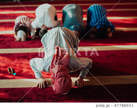 A group of Muslims in a modern mosque praying the Muslim prayer namaz, during the holy month of Ramadan A group of Muslims in a modern mosque praying the Muslim prayer namaz, during the holy month of Ramadan 97786031