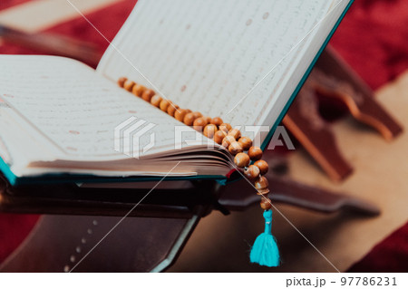 Photo of the holy Islamic book of the Qoran in a modern mosque Photo of the holy Islamic book of the Qoran in a modern mosque 97786231